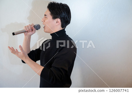 Japanese man singing enthusiastically into a microphone 126007741
