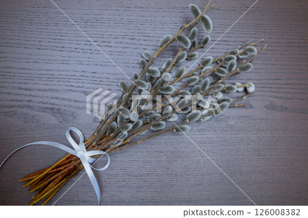 willow branches on a wooden table orange ribbon, Easter symbol, palm Sunday.Top view 126008382