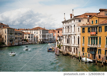 Venice - April 20, 2025 Picturesque view of a Venice canal taken from a bridge. Historic buildings with colorful facades 126008638