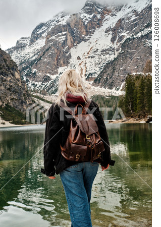 Mountain lake Braies in Italy. Girl in front of the lake looks at the beautiful landscape 126008698