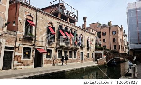 Picturesque view of a Venice canal taken from a bridge. Historic buildings with colorful facades 126008828