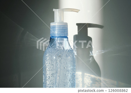 Tube of micellar gel in a ray of sunlight on a shadow background. 126008862