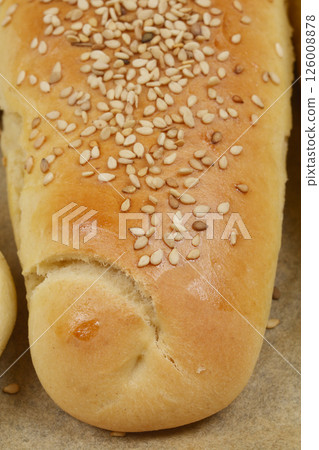 Baked dough roll with sesame seeds Baked dough roll with sesame seeds 126008878