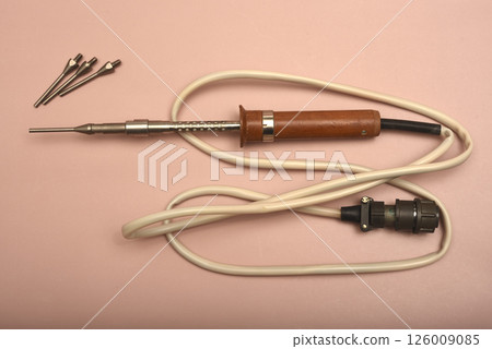 An old soldering iron with a silver tip. 126009085