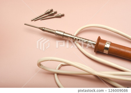 An old soldering iron with a silver tip. An old soldering iron with a silver tip. 126009086