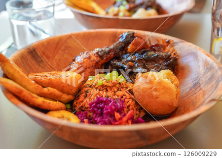 Caribbean Lamb Honey Chicken, Jamaican Fried Dumplings, Deep Fried Sweet Plantain 126009229