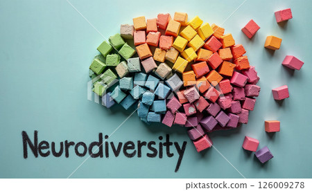 Textured Rainbow Brain Sculpture Made of Pastel Blocks with Neurodiversity Chalk Text on Black Surface 126009278