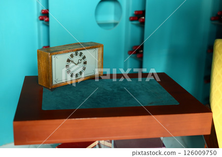 A Vintage Clock Sitting Gracefully on a Retro Table in a Colorful and Inviting Room 126009750
