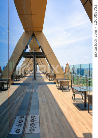ComfortabComfortable seating area on top of a skyscraper, Service area on rooftop le seating area on top of a skyscraper, Service area on rooftop bar and restaurant area with beautiful cityscape view. ComfortabComfortable seating area on top of a skyscraper, Service area on rooftop le seating area on top of a skyscraper, Service area on rooftop bar and restaurant area with beautiful cityscape view. 126009752