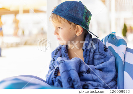 Young Boy Relaxing at the Beach 126009953