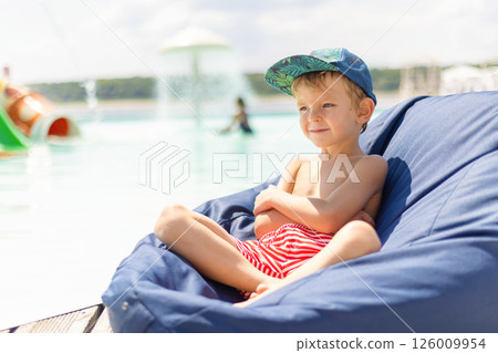 Child Relaxing by the Poolside 126009954