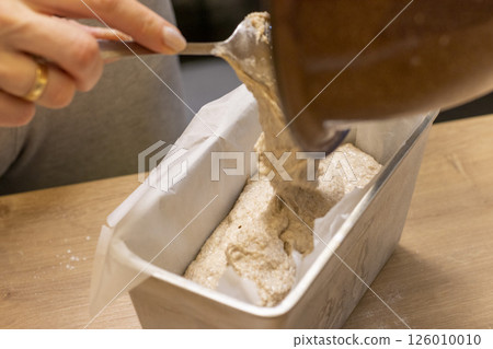 Close up shot of the dough in the bawl on the kitchen counter top 126010010