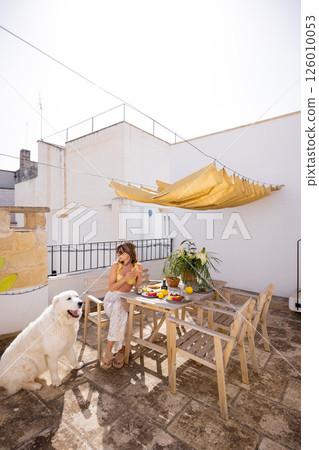 Sunny Mediterranean breakfast on rustic rooftop 126010053