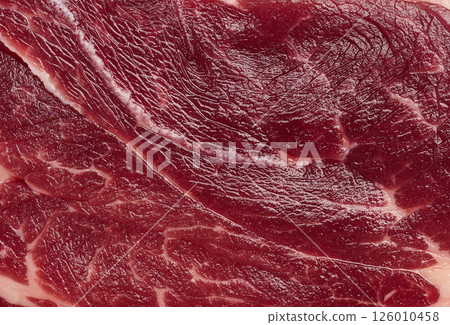 Detailed close up of fresh raw red meat texture with white fat marbling. High quality beef or steak for culinary use Detailed close up of fresh raw red meat texture with white fat marbling. High quality beef or steak for culinary use 126010458