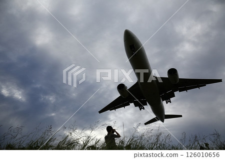 A grazing airplane overhead A grazing airplane overhead 126010656