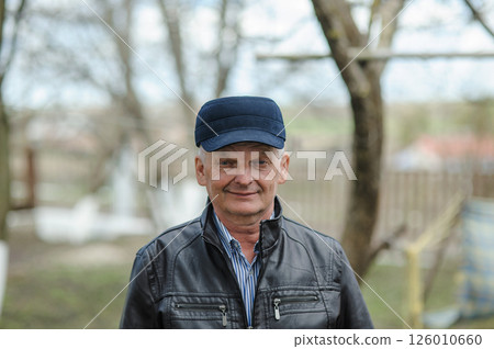Pensioner smiling on the street. An old man enjoying life. Pensioner smiling on the street. An old man enjoying life. 126010660