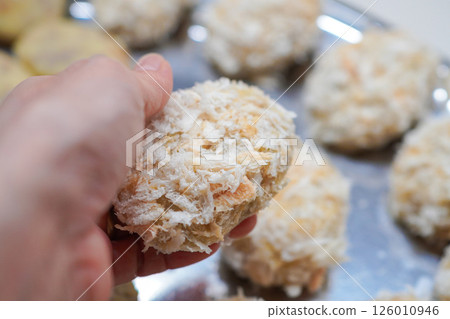 A woman's hands making homemade croquettes using raw breadcrumbs A woman's hands making homemade croquettes using raw breadcrumbs 126010946