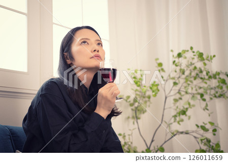 一名 40 多歲的女性白天在家喝酒 一名 40 多歲的女性白天在家喝酒 126011659