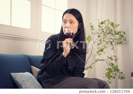 一名 40 多歲的女性白天在家喝酒 126011709