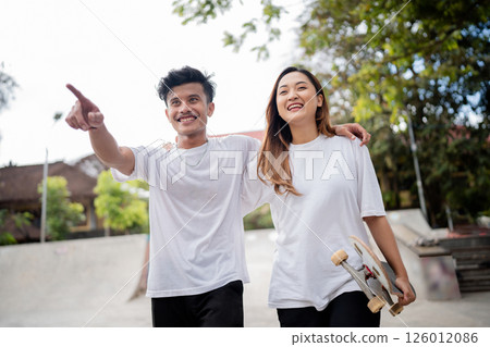 Happy Skateboarding Friends Are Enjoying Their Fun Day in the Park Together Happy Skateboarding Friends Are Enjoying Their Fun Day in the Park Together 126012086