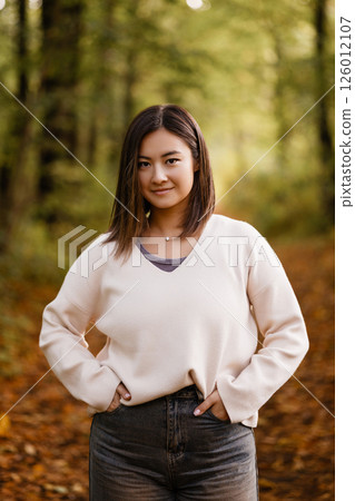 Young Woman Smiling in Autumn Forest Path 126012107