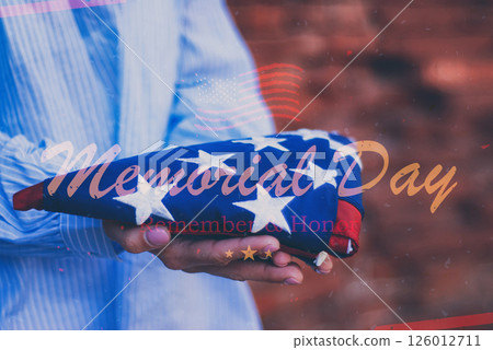 Woman holding folded american flag for Memorial Day tribute remember and honor veterans. Woman holding folded american flag for Memorial Day tribute remember and honor veterans. 126012711