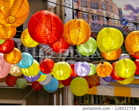 Multicolored Chinese lanterns hanging above the street. 126012719