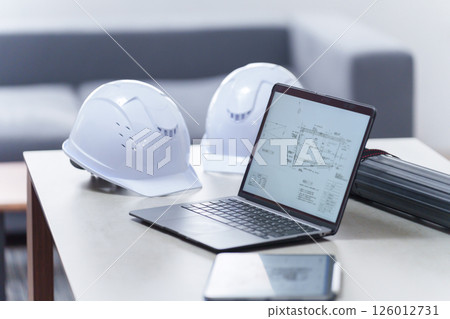 Helmet and laptop in the office (unmanned) 126012731