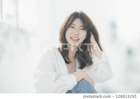 Young woman relaxing in the living room Young woman relaxing in the living room 126013295