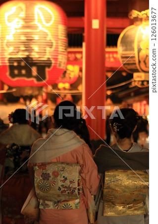 A woman in a kimono visiting Sensoji Temple at night A woman in a kimono visiting Sensoji Temple at night 126013677