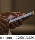 A young woman handling a smartphone 126013820