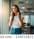 Young blonde woman talking on smartphone 126013821