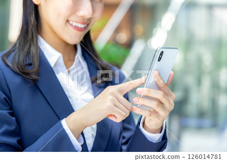 Business woman operating a smartphone 126014781