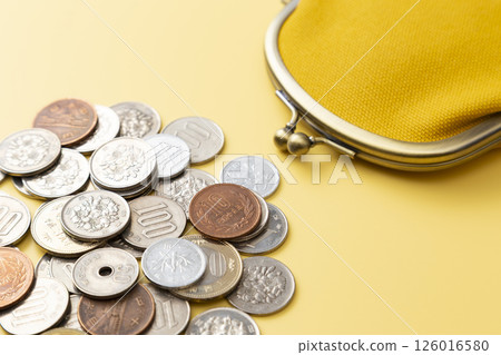 Coins and wallet on a yellow background 126016580