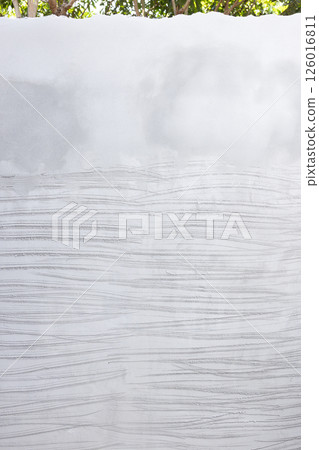 Concrete plastering wall and scrate surface to prepare for tile installation. 126016811