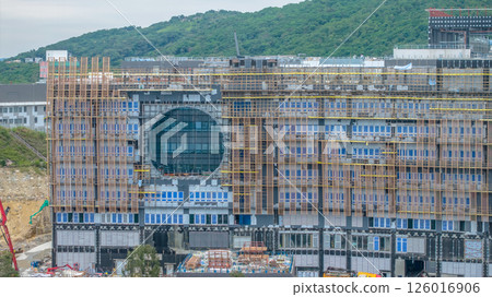 MAY 10 2025 Large Building Under Construction with Scaffolding and Mountain 126016906