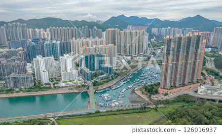 MAY 10 2025 View of a Large Urban Construction Site Amid Surrounding Greenery 126016937