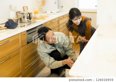 Male worker repairing the kitchen Male worker repairing the kitchen 126016959