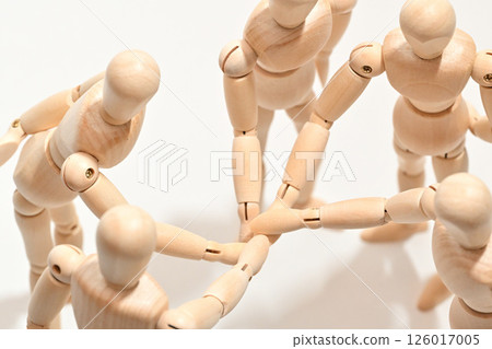 Image of people standing in a circle, stacking their hands to confirm unity. Image of people standing in a circle, stacking their hands to confirm unity. 126017005