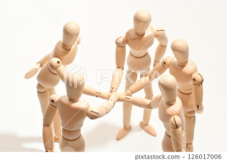 Image of people standing in a circle, stacking their hands to confirm unity. Image of people standing in a circle, stacking their hands to confirm unity. 126017006