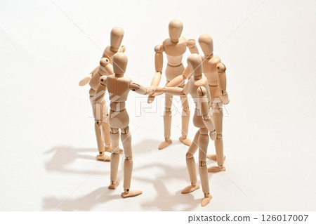 Image of people standing in a circle, stacking their hands to confirm unity. Image of people standing in a circle, stacking their hands to confirm unity. 126017007