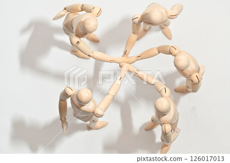 Image of people standing in a circle, stacking their hands to confirm unity. Image of people standing in a circle, stacking their hands to confirm unity. 126017013