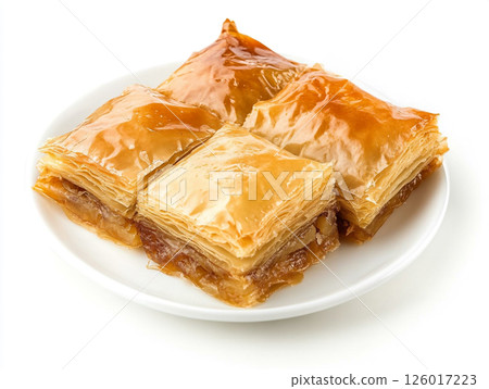 Baklava isolated on a white background. Baklava is a sweet pastry made of layers of filo dough filled with chopped nuts and sweetened with syrup or honey. 126017223