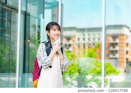 A young college student woman with a smartphone 126017590