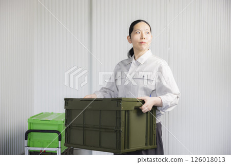 Middle-aged woman wearing work clothes 126018013