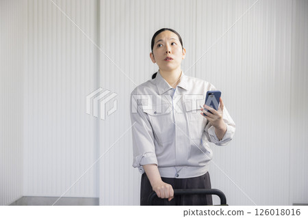 Middle-aged woman wearing work clothes Middle-aged woman wearing work clothes 126018016