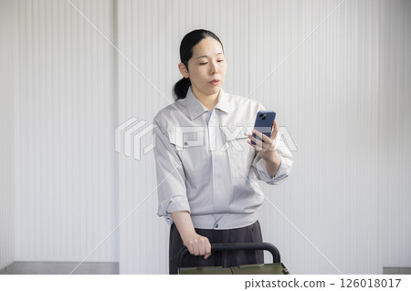 Middle-aged woman wearing work clothes 126018017