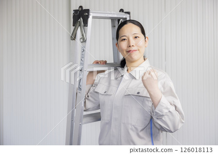 Middle-aged woman wearing work clothes 126018113