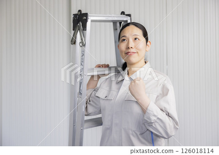 Middle-aged woman wearing work clothes 126018114