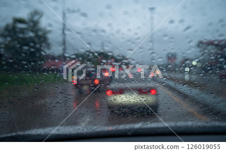 Rain drop on the car glass window while driving on the road. 126019055